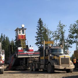 heavy equipment being pulled with a truck